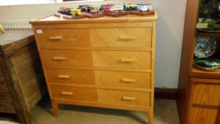A 4 drawer light oak chest of drawers
