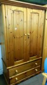 A pine wardrobe over 2 drawers