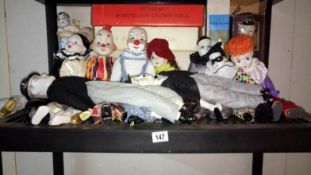 A shelf of ceramic dolls & clowns