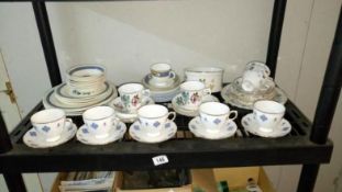 A shelf of porcelain including tea set