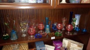 A quantity of coloured glass items including vintage glasses