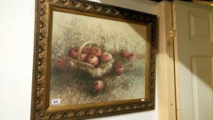 A framed picture of apples in a basket