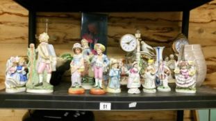 A shelf of miscellaneous pottery including clocks