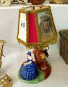 A table lamp with figure base