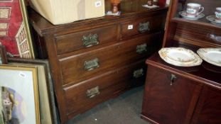 A 2 over 2 dark wood chest of drawers