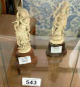 2 ivory figures on wooden bases