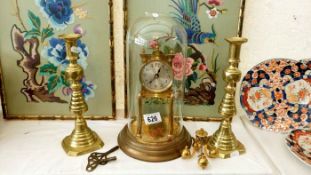 A clock under glass dome & 2 candlesticks etc.