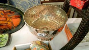 A large decorative silver plate bowl