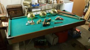 A snooker table with cues & lights etc.