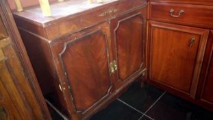 A leather topped 2 door cupboard