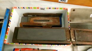 A box containing plane blades & sharpening steels