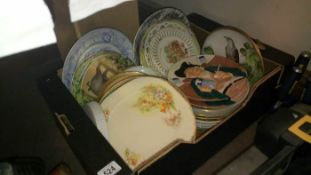 A box of assorted collectable plates