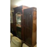 A Victorian mahogany triple wardrobe with central mirror door