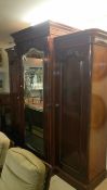 A Victorian mahogany triple wardrobe with central mirror door