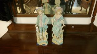 A pair of continental bisque porcelain figures