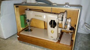A vintage Singer sewing machine in crocodile skin effect case