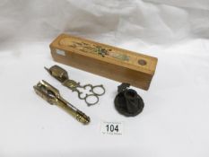 A brass nutcracker with portrait of William Shakespeare, a brass candle snuffer,