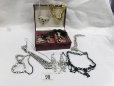 A jewellery box and contents including necklaces,