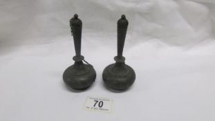 A pair of Arabic lidded metal scent bottles