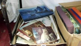 A box of various unframed prints