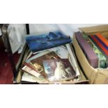 A box of various unframed prints