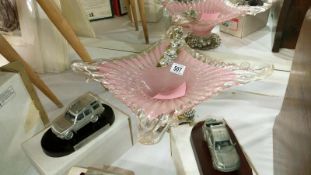 A pink glass bowl on stand