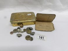 A WW1 Christmas tin containing soldiers pay book and a small quantity of military buttons