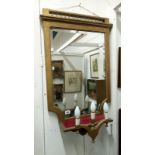 A gilded wall mirror with attached lights