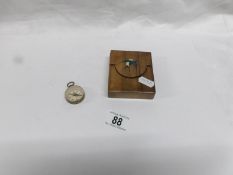 A treen pocket watch case and a small compass