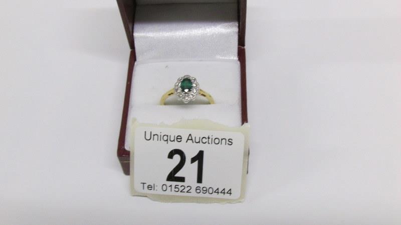 A high carat yellow gold emerald and diamond ring,