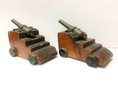 A pair of old brass signal cannons (that may fire) on pine carriages with brass wheels