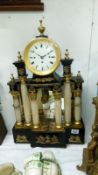 A ornate mantel clock with columns