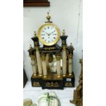 A ornate mantel clock with columns