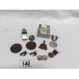 A mixed lot of commemorative medals and badges, vintage pedometer,