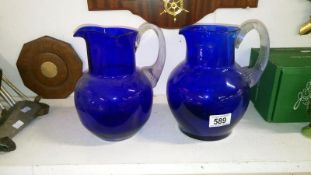 2 blue glass jugs