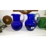 2 blue glass jugs