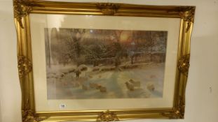 A gilt framed and glazed print of sheep in winter landscape