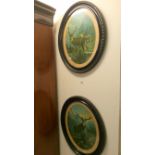 A pair of oval framed and glazed stag prints