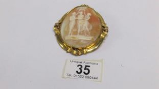 A three graces cameo brooch set in yellow metal