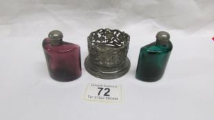 A pair of coloured glass scent bottles in metal stand