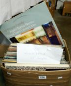 A box of approximately 80 mixed LP records and 12" singles