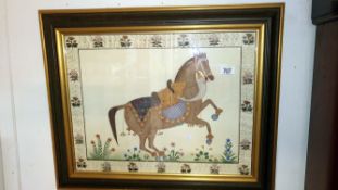 A framed and glazed fabric picture of a horse