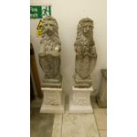 A pair of garden lions on pedestals and holding shields