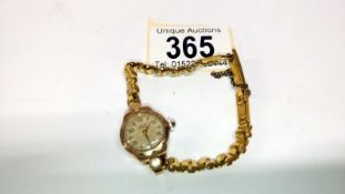 An Avia ladies 9ct gold cased wrist watch with plated strap