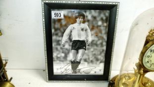 A signed photograph of footballer Maradonna