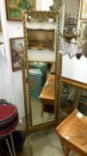 A gilt framed cheval mirror