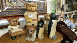 4 wooden bear figures and 2 wooden penguin figures