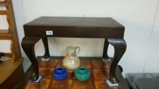 A dark oak dressing table stool on Queen Anne style legs