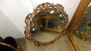 A gilt framed wall mirror