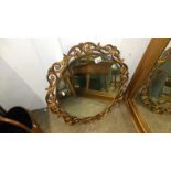 A gilt framed wall mirror